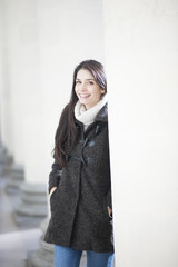 portrait of handsome woman with whites columns in backgound