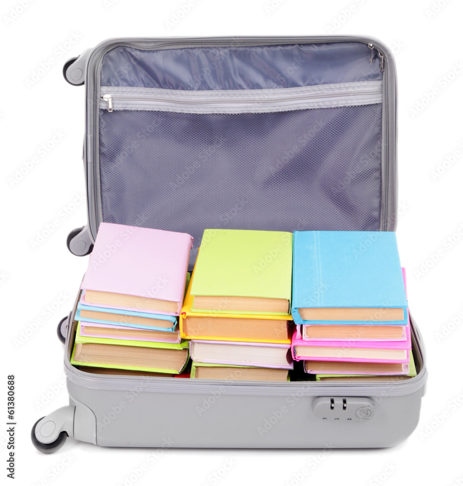 Suitcase with books isolated on white
