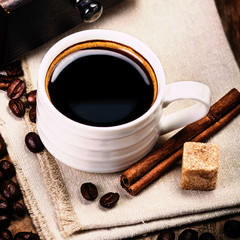Poster - Espresso Cup on brown napkin with cinnamon and sugar.