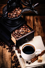 Poster - Cup of coffee with coffee beans and Coffee grinder on wooden bro