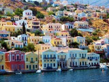 Fototapeta  - beautiful colorful houses on hill, Symi island, Greece