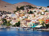 Fototapeta  - beautiful colorful houses on hill, Symi island, Greece