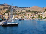 Fototapeta  - Old harbor with boats at Symi, Greece