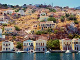 Fototapeta  - beautiful colorful houses on hill, Symi island, Greece