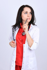 A portrait of a sexy woman doctor in medical white and red unifo