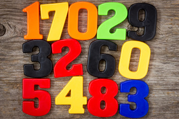 Wall Mural - Plastic numbers on the wooden background