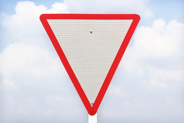 Wall Mural - yield traffic sign on blue  sky  background