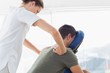 © WavebreakmediaMicro - Physiotherapist giving back massage to man