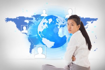 Poster - Composite image of businesswoman sitting cross legged frowning