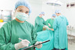 © Tom Wang - woman Surgeons writing medical record in operation room