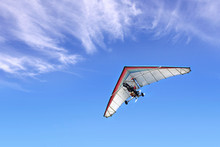 Motorized Hang Glider In The Blue Sky
