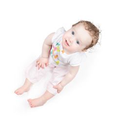 Wall Mural - Funny baby girl sitting on white background