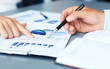 © ty - Unrecognizable business person analyzing graphs