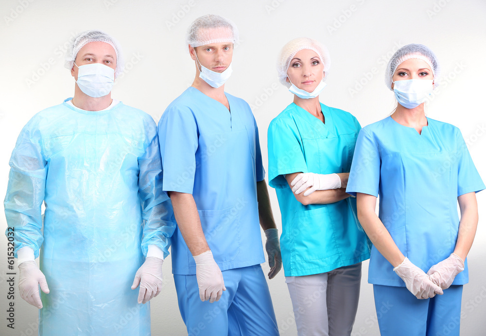 Surgeons standing on grey background