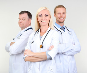 Canvas Print - Medical workers on grey background