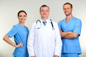 Canvas Print - Medical workers on grey background