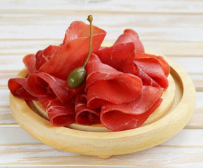 Poster - Smoked meat bresaola snack on a cutting board