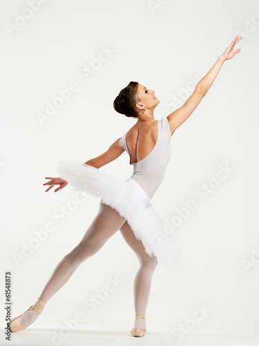 Fotografie, Obraz Young ballerina dancer in tutu showing her techniques