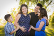 © Andy Dean - Happy Attractive Hispanic Family With Their Pregnant Mother Outd