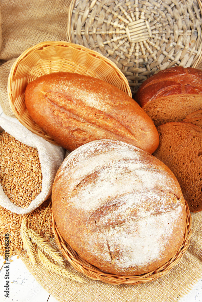 Rye bread with grains on table on sackcloth background
