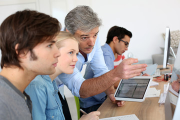 teacher using digital tablet in school class