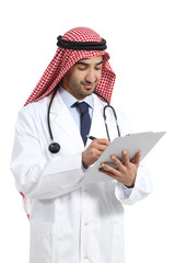 Wall Mural - Arab saudi doctor man working writing in a clinical history