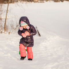 Sticker - Little girl pulls a sled in warm winter day