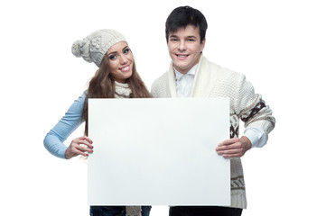 Poster - young smiling winter couple holding big sign