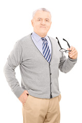 Canvas Print - Senior gentleman holding a pair of glasses