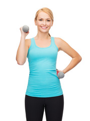 Canvas Print - young sporty woman with light dumbbells