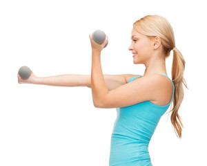 Wall Mural - young sporty woman with light dumbbells