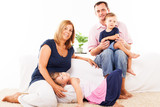 Fototapeta Panele - Beautiful happy family sitting in the living room.