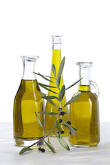 Wall Mural - pure of oil bottles and raw black olives branch