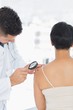 © WavebreakMediaMicro - Dermatologist examining mole on woman