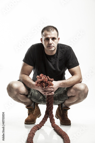 Fotografie, Obraz man doing rope training isolated on white - boot camp