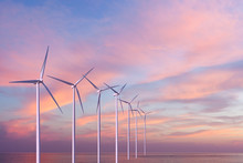 Wind Generators Turbines In The Sea On Sunset