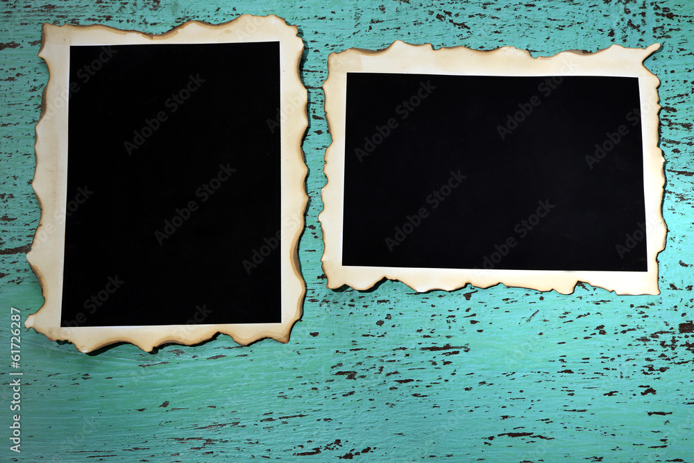 Blank old photos on color wooden background