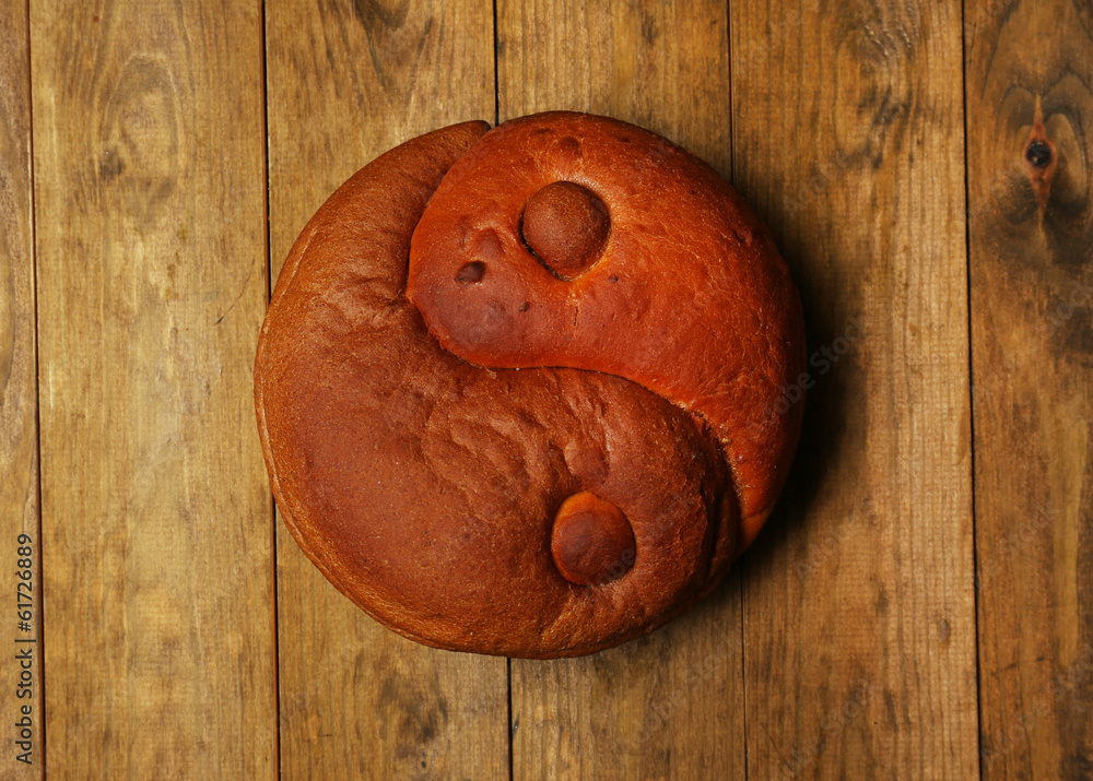 Loaf of bread on wooden background