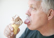 Man licks ice cream cone