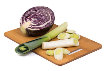 Cut scotch kale and leeks on the wooden cutting board.