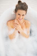© Alliance - Portrait of smiling young woman in bathtub