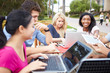 © Monkey Business - Group Of University Students Working On Project Outdoors