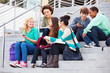 © Monkey Business - Group Of High School Students Sitting Outside Building