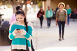 © Monkey Business - Female Student Walking To High School Using Mobile Phone