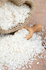 Wall Mural - rice in a burlap bag on wooden surface