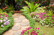 Stone Paved Garden Path with a Lawn and Flowerbed