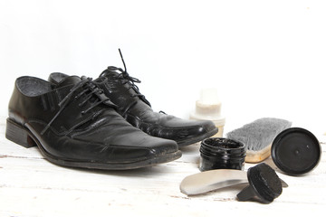 shoe care equipment and formal black shoe on white background