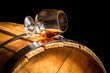 Glass of cognac on the vintage barrel