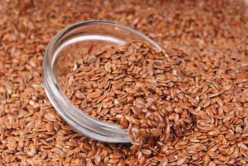 Wall Mural - close up of flax seeds and bowl food background