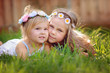 © fotoskaz - portrait of two happy little sisters on green grass